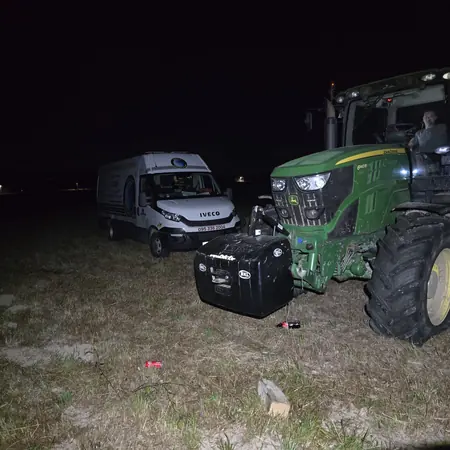 Noćna intervencija na traktoru u polju, uz servisno vozilo